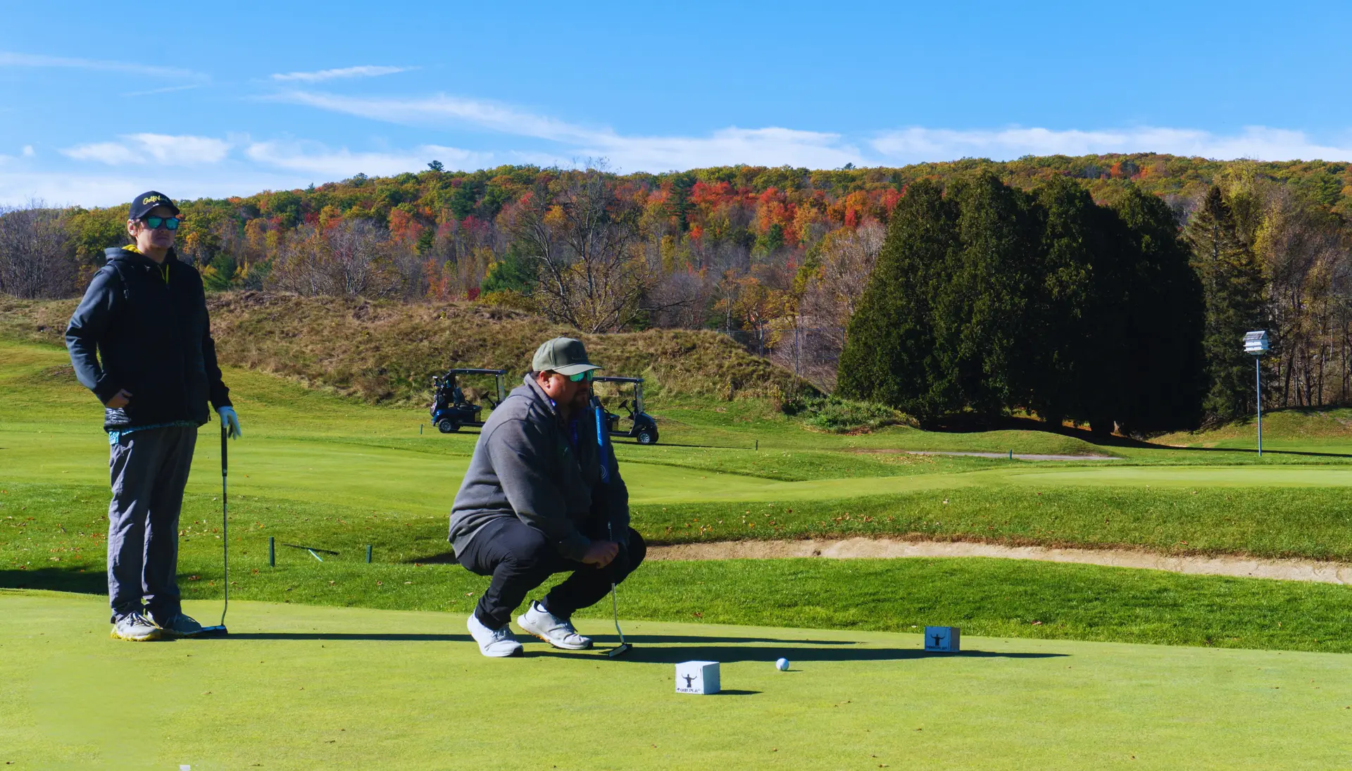 Golfers reading a putt during Green Mountain Classic competition